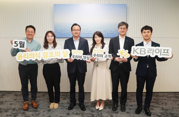 이환주 대표이사 사장(좌측 세번째)이 표어 공모전 수상자인 김태연 매니저(좌측 네번째), 권성안 준법감시인(좌측 다섯번째) 등과 기념촬영을 하고 있다./사진=KB라이프생명