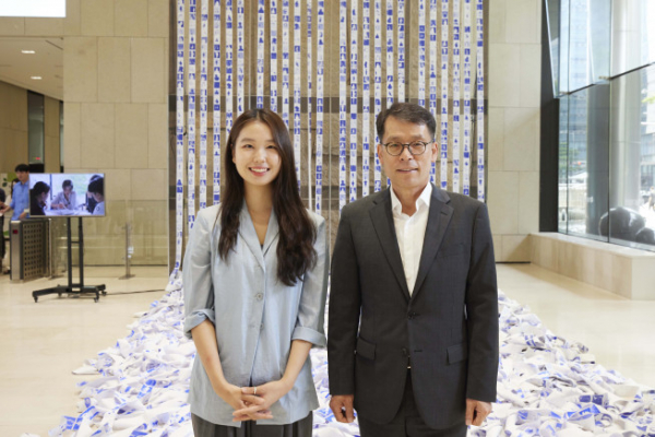 ▲지난 12일 서울 중구 을지로 기업은행 본점에서 김성태 IBK기업은행장(오른쪽)과 조현서 작가(왼쪽)가 기념 촬영을 하고 있는 모습./사진=기업은행