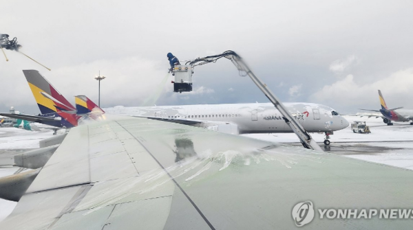 폭설이 내린 27일 오전 영종도 인천국제공항 1터미널에서 인천발 나고야행 아시아나항공 여객기 날개의 눈을 녹이는 작업이 이뤄지고 있다./사진=연합뉴스